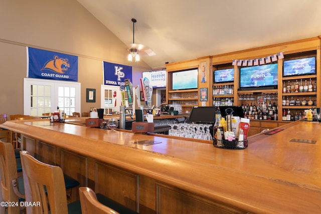 bar with butcher block countertops, lofted ceiling, french doors, and ceiling fan