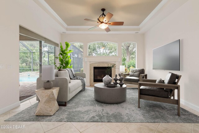 living room with plenty of natural light, ceiling fan, and a tray ceiling