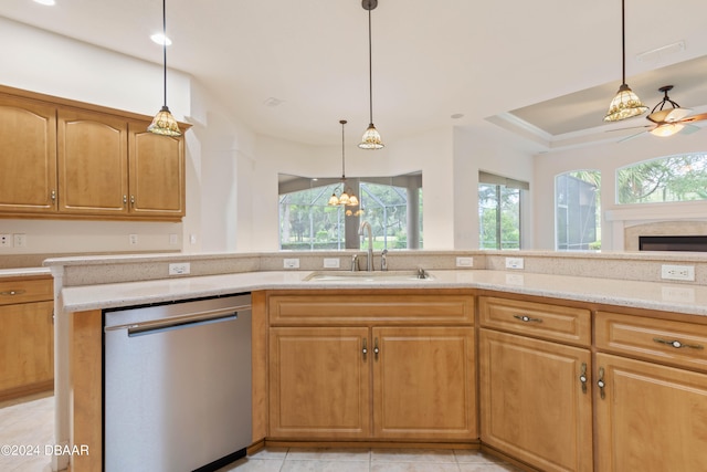 kitchen with light tile patterned flooring, pendant lighting, sink, stainless steel dishwasher, and ceiling fan with notable chandelier