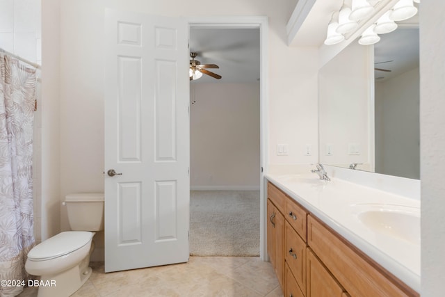 bathroom with toilet, vanity, and tile patterned floors