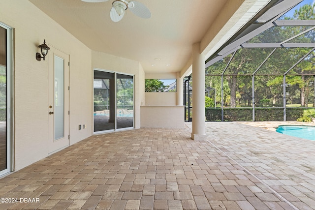 view of patio / terrace featuring glass enclosure and ceiling fan