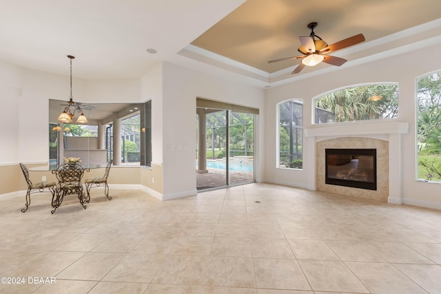 unfurnished living room featuring light tile patterned floors, a healthy amount of sunlight, and a tile fireplace