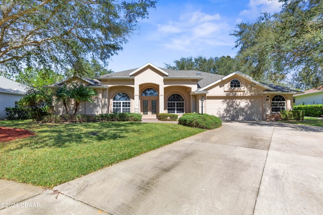 view of front of property with a garage and a front lawn