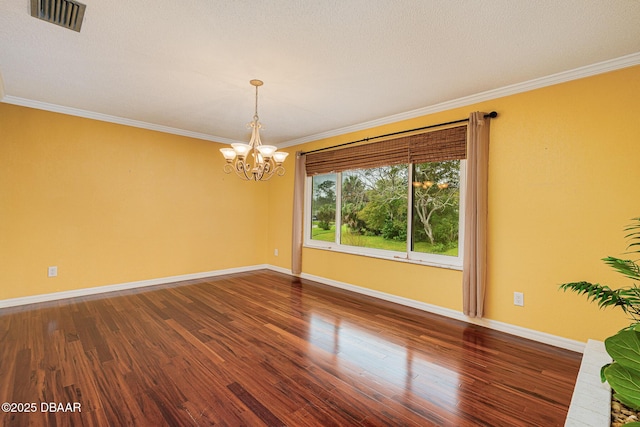 unfurnished room featuring ornamental molding, visible vents, and wood finished floors