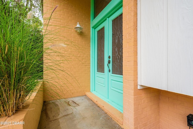 doorway to property with brick siding