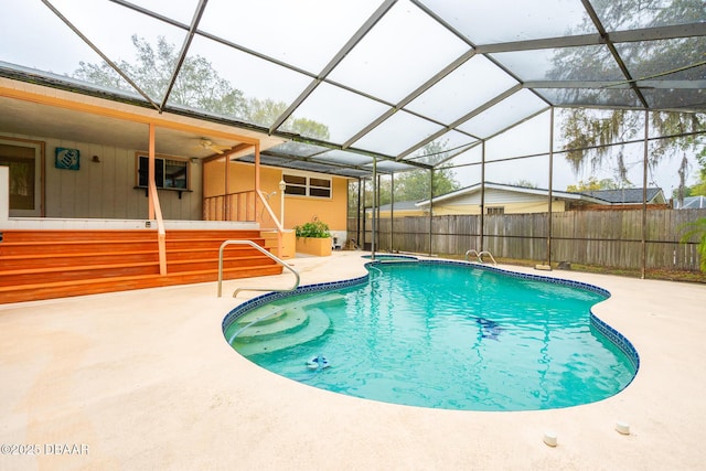 view of swimming pool with a lanai, a patio area, fence, and a fenced in pool