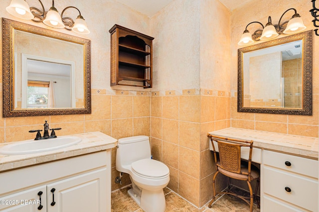 bathroom with tile walls, toilet, and vanity