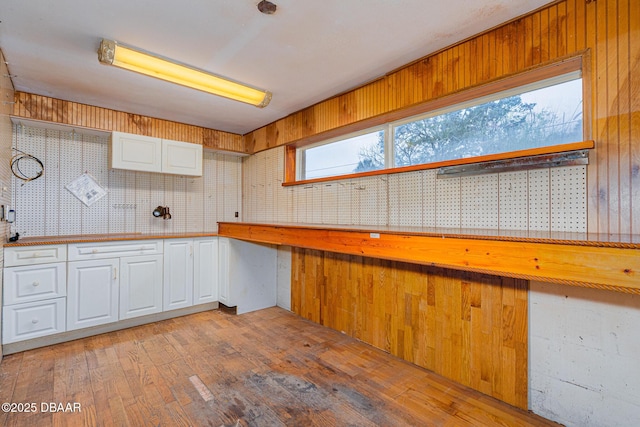 kitchen featuring light wood-type flooring and white cabinets