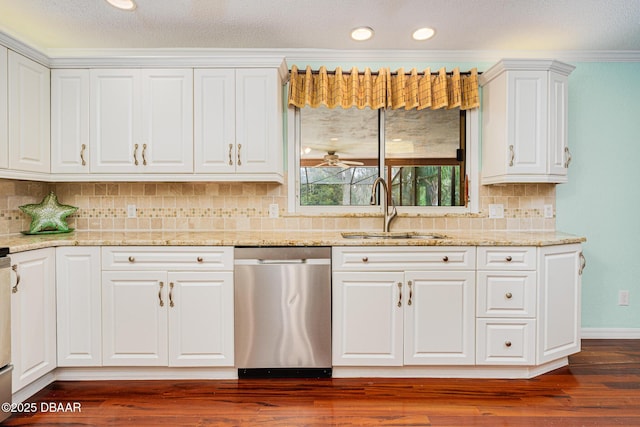 kitchen featuring light stone counters, dark wood finished floors, white cabinets, a sink, and dishwasher