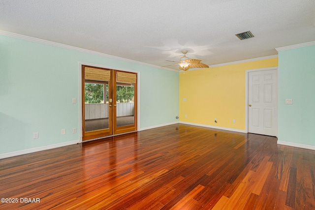 empty room featuring ornamental molding, french doors, wood finished floors, and visible vents