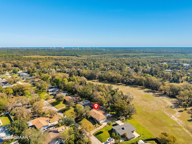 birds eye view of property featuring a wooded view