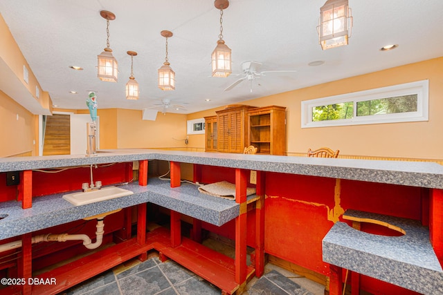 interior space with ceiling fan, a sink, and recessed lighting