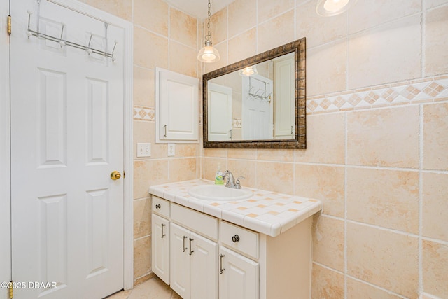 bathroom with tile walls and vanity