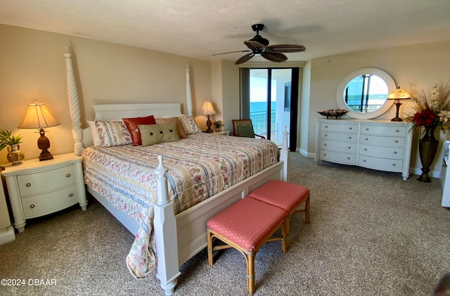 carpeted bedroom featuring access to outside, a water view, and ceiling fan