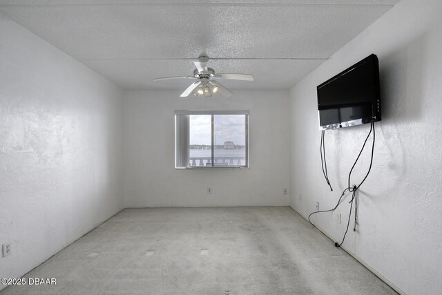 405 N Halifax Ave N Unit 208, Daytona Beach, FL 32118 - empty room with carpet floors, a ceiling fan, and a textured ceiling