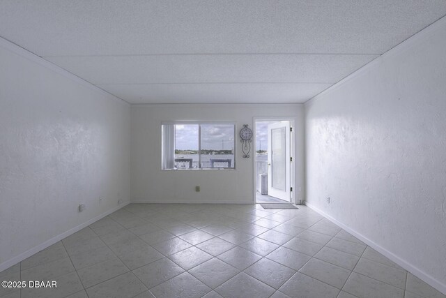 405 N Halifax Ave N Unit 208, Daytona Beach, FL 32118 - empty room with a textured ceiling, tile patterned floors, and ornamental molding