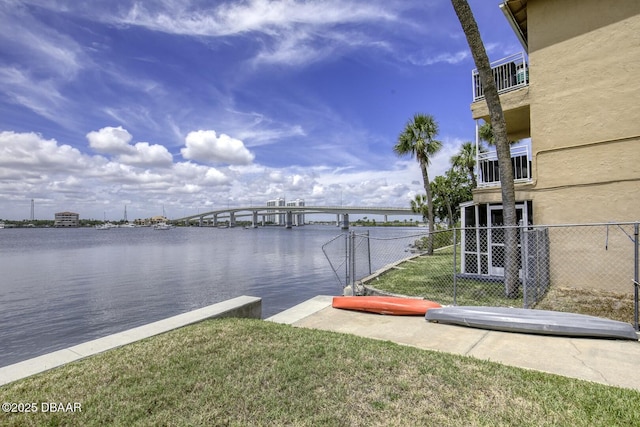 405 N Halifax Ave N Unit 208, Daytona Beach, FL 32118 - view of dock with a lawn, a water view, and fence