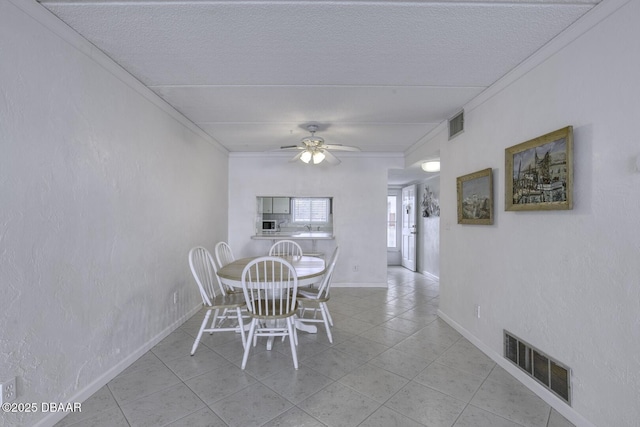 405 N Halifax Ave N Unit 208, Daytona Beach, FL 32118 - dining area with crown molding, light tile patterned floors, a textured ceiling, and visible vents