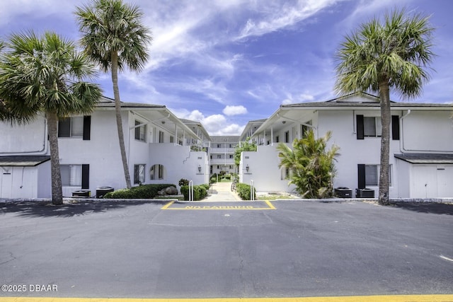 405 N Halifax Ave N Unit 208, Daytona Beach, FL 32118 - view of building exterior featuring uncovered parking and central AC