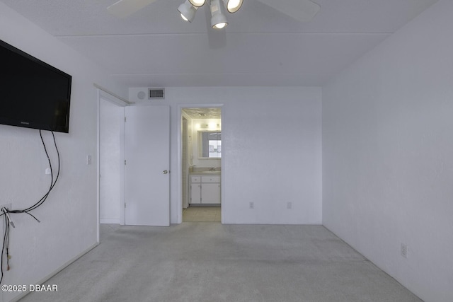 405 N Halifax Ave N Unit 208, Daytona Beach, FL 32118 - unfurnished bedroom featuring ceiling fan, a sink, carpet, ensuite bathroom, and visible vents