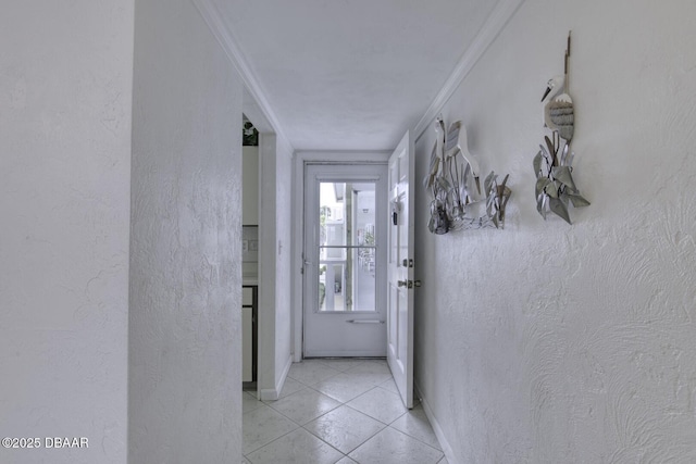 405 N Halifax Ave N Unit 208, Daytona Beach, FL 32118 - doorway featuring baseboards, ornamental molding, a textured wall, and light tile patterned flooring