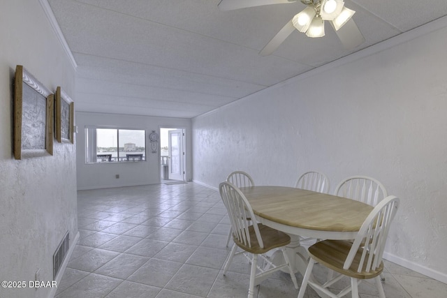 405 N Halifax Ave N Unit 208, Daytona Beach, FL 32118 - dining room featuring visible vents, crown molding, light tile patterned flooring, baseboards, and a ceiling fan