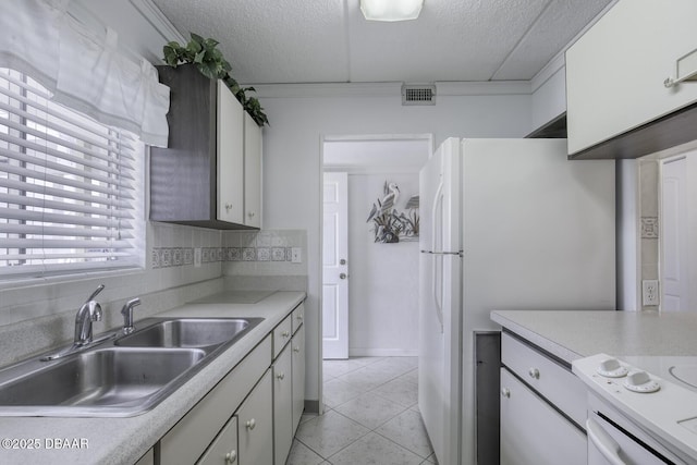 405 N Halifax Ave N Unit 208, Daytona Beach, FL 32118 - kitchen featuring a sink, light countertops, a textured ceiling, light tile patterned floors, and visible vents
