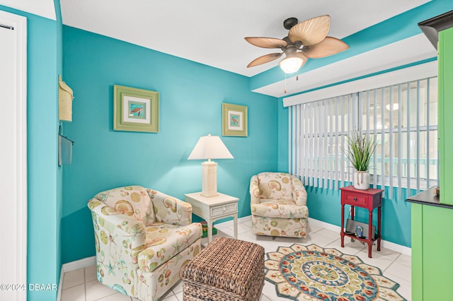 sitting room with light tile patterned flooring and ceiling fan