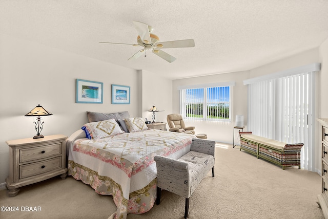 bedroom featuring a textured ceiling, carpet floors, and ceiling fan