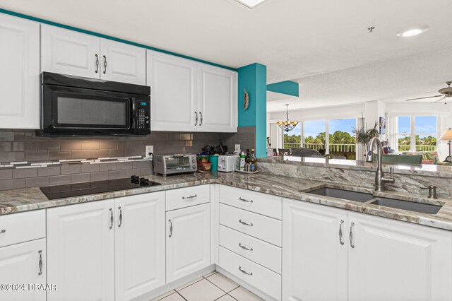 kitchen with white cabinets, black appliances, and sink