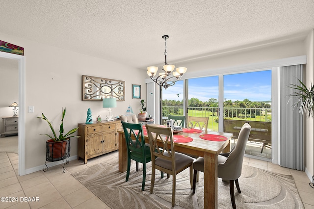 dining area with a textured ceiling and light tile patterned flooring