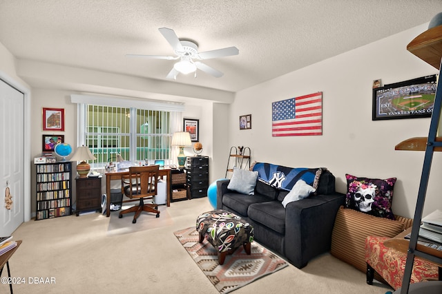 carpeted living room with ceiling fan and a textured ceiling