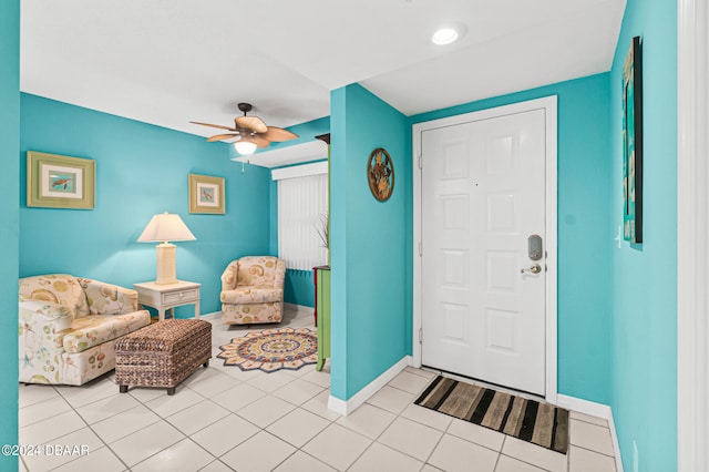 tiled entrance foyer featuring ceiling fan