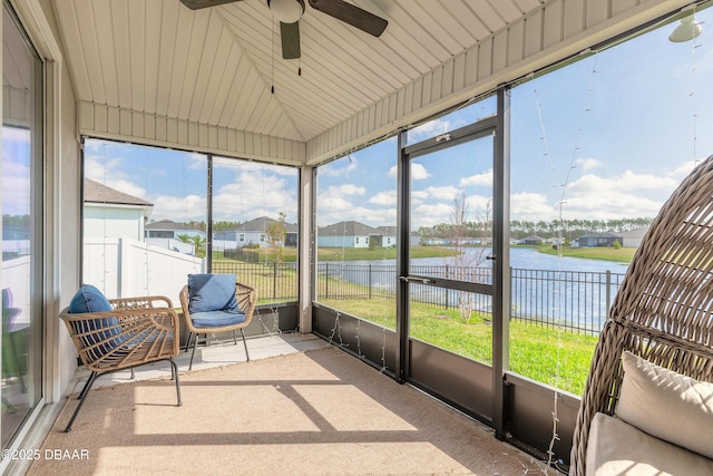 sunroom / solarium with a water view, ceiling fan, and lofted ceiling