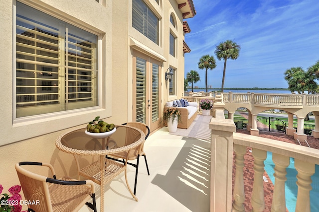 view of patio / terrace featuring a water view and a balcony