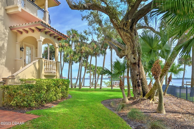 view of yard featuring a balcony and a water view