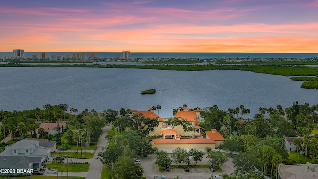 aerial view at dusk with a water view