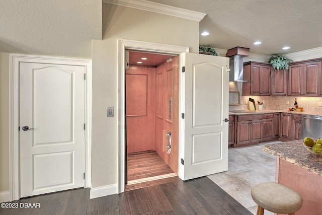 kitchen with tasteful backsplash, a textured ceiling, wall chimney range hood, light wood-type flooring, and dishwasher