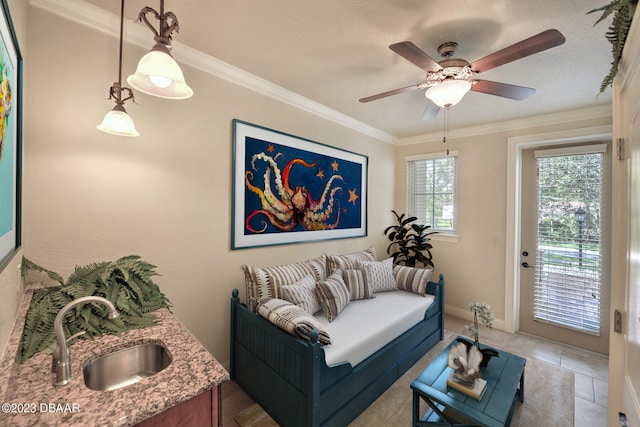 living room featuring ornamental molding, sink, ceiling fan, and light tile patterned floors