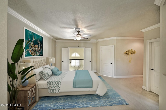 carpeted bedroom featuring a textured ceiling, ceiling fan, and crown molding