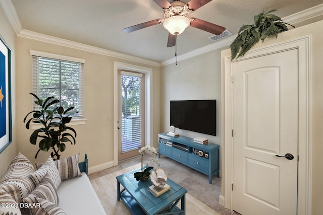 living room with light colored carpet, ceiling fan, and crown molding