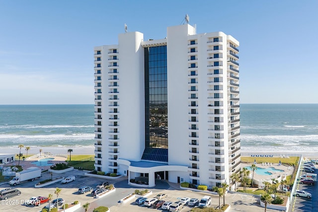 view of property with a beach view and a water view