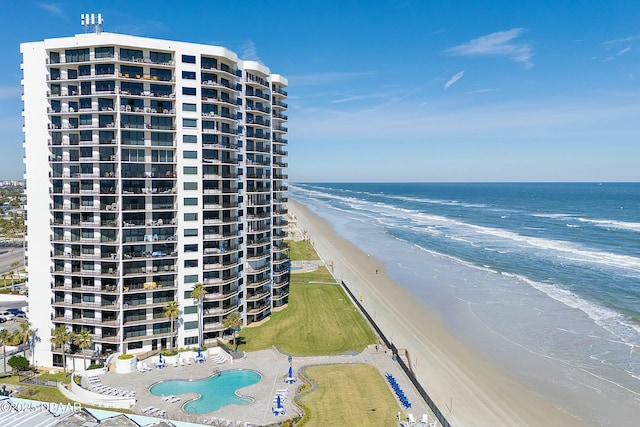 exterior space featuring a water view and a beach view