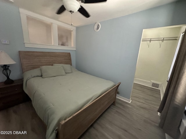 bedroom with a closet, ceiling fan, and dark wood-type flooring