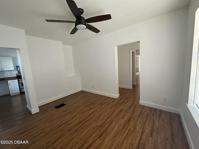 unfurnished living room featuring dark hardwood / wood-style floors and ceiling fan