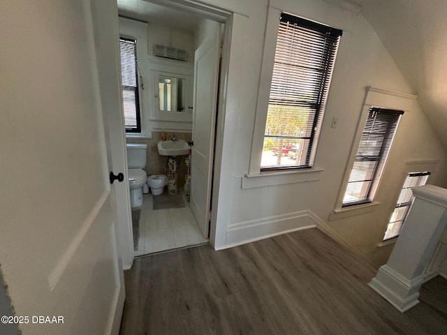 corridor featuring sink and dark hardwood / wood-style flooring