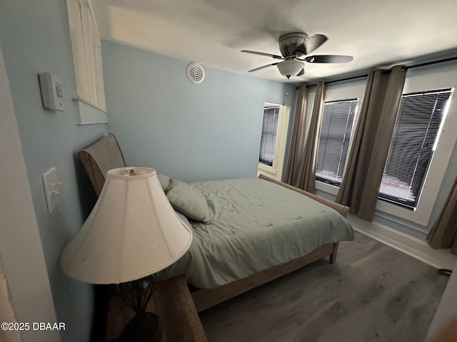 bedroom featuring dark hardwood / wood-style floors and ceiling fan