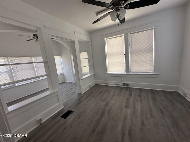 empty room featuring dark hardwood / wood-style floors and ceiling fan