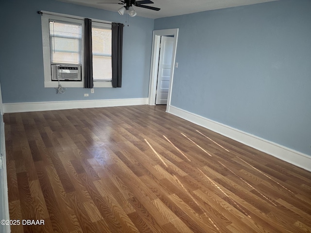 spare room featuring wood-type flooring, cooling unit, and ceiling fan