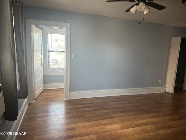 spare room with ceiling fan and dark hardwood / wood-style flooring